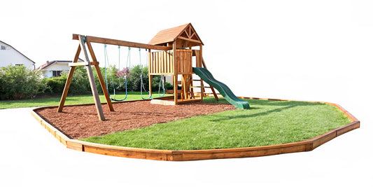 Backyard playspace with a swing set surrounded by a curved border edging filled with wood mulch